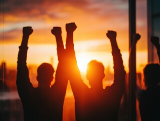people with Fists Raised at Sunset