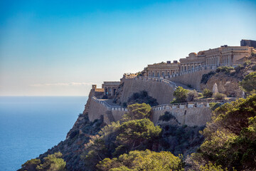 Disused military buildings on a mountain at Cape Tiñoso in Cartagena, Murcia Region, Spain, with the Mediterranean Sea in the background © AntonioLopez
