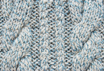 Soft light blue wool crossed cable ornament texture as background