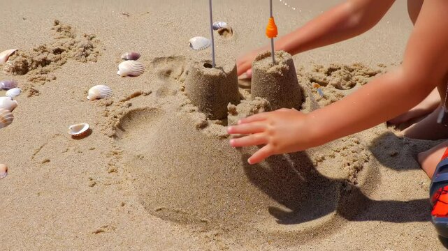 Child building sandcastle on beach
