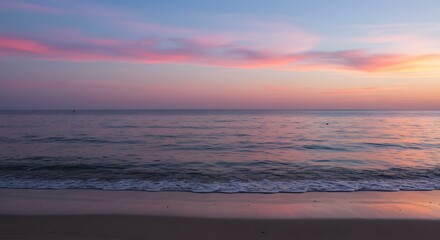 Fototapeta premium Peaceful Beach at Dusk with Pink Clouds and Calm Ocean Water