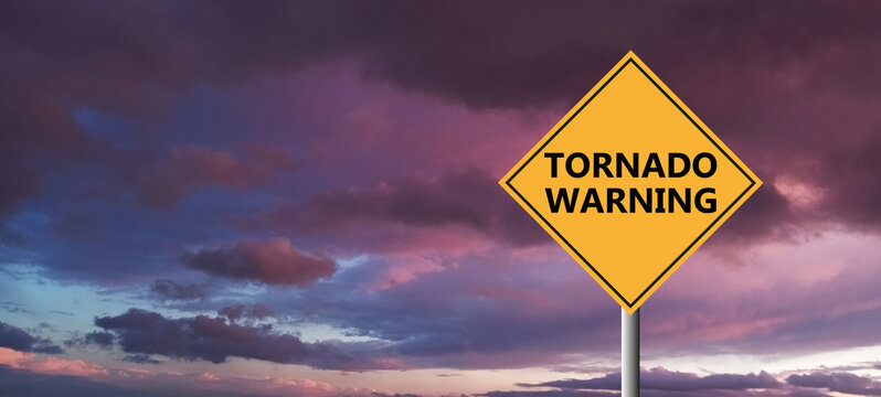 tornado warning sing against a powerful stormy background with copy space. dirty and angled sing with cyclonic winds add to the drama