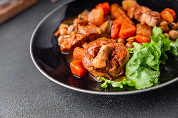 Ragout meat, sausages, vegetables stew dish fresh tasty food delicious gourmet food background on the table rustic food top view copy space