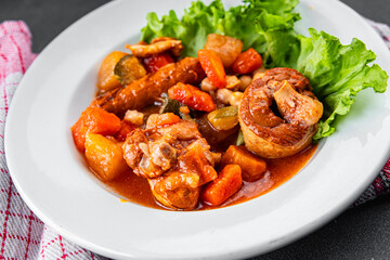 Ragout meat, sausages, vegetables stew dish fresh tasty food delicious gourmet food background on the table rustic food top view copy space