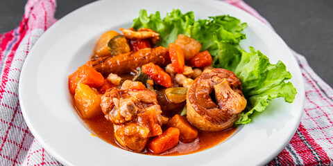 Ragout meat, sausages, vegetables stew dish fresh tasty food delicious gourmet food background on the table rustic food top view copy space