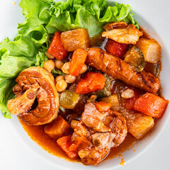 Ragout meat, sausages, vegetables stew dish fresh tasty food delicious gourmet food background on the table rustic food top view copy space