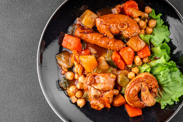 Ragout meat, sausages, vegetables stew dish fresh tasty food delicious gourmet food background on the table rustic food top view copy space