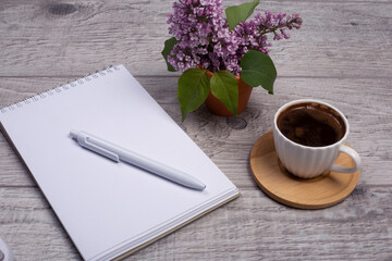  coffee, flower and notebook on wooden background
