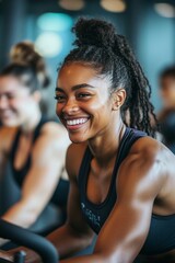 Fototapeta premium Smiling woman in gym, riding indoor bicycle