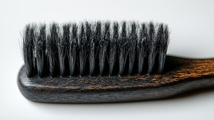Close-up view of a black dye brush with comb for hair coloring and styling tasks