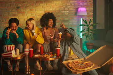 Cheerful friends socializing indoors.