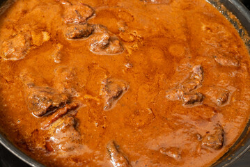 closeup of beef cheeks sauteed in rich wine rosemary and vegetable gravy