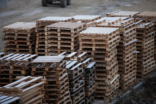 Pile of wooden pallets at a construction site