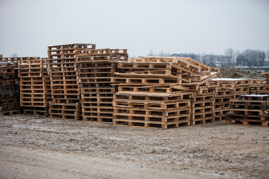 Pile of wooden pallets at a construction site