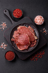 Jerky, dried pork meat slices with salt and spices