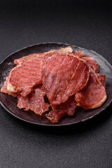 Jerky, dried pork meat slices with salt and spices