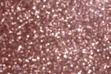 Elegant rose gold glitter texture with a sparkling bokeh effect background
