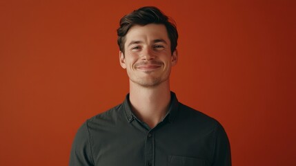 Fototapeta premium Smiling Man Portrait on Orange Background, Content Young Adult