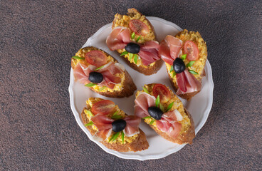 Bruschetta with jamon, egg and cherry tomatoes, Top view