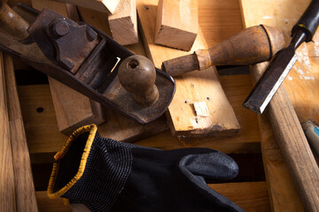 Old carpentry work tools on a  wooden table background.