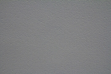 Close-up of a textured popcorn ceiling surface, showing a rough and uneven pattern typical in older homes.