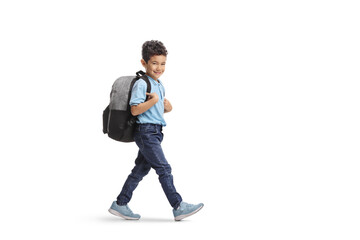 Kid with a backpack walking and smiling at camera