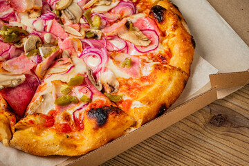 Delicious Pizza Topped With Mushrooms, Ham, and Pickled Onions on a Wooden Table, Capturing the Warm Essence of Comfort Food Dining.