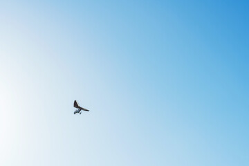 Hang glider for riding tourists in the field. Two-seater hang glider flying in the sky