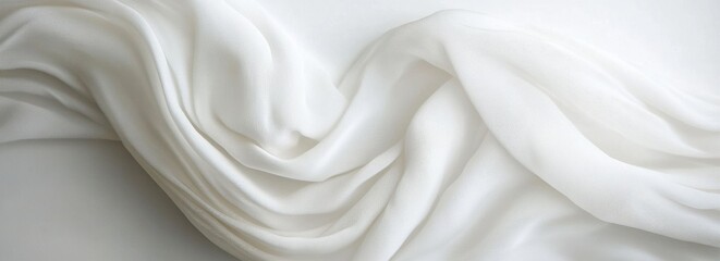 White fabric draped, flowing on white background;  texture backdrop