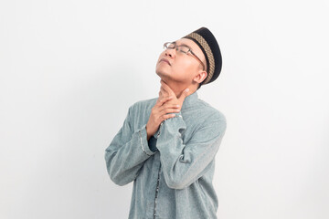 Asian Muslim man touching neck, thirsty gesture during fasting in Ramadan Eid Al Fitr and eid adha...