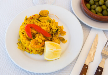 Appetizing seafood dish Paella with shrimp. Spanish cuisine. High quality photo