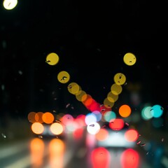 Car traffic lights bokeh through rainy window glass on black background defocused city night colorful round lights Bokeh light lights background bokeh abstract light bright effect shiny