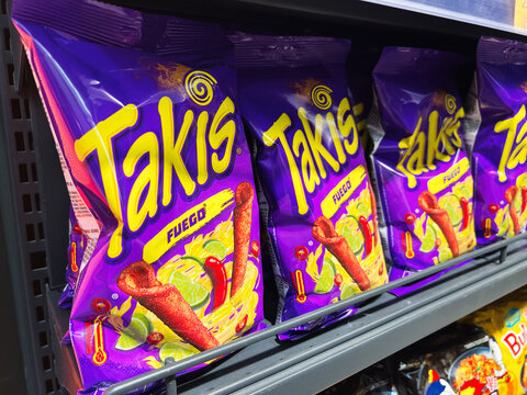 Kyiv, Ukraine - February 11, 2025: Colorful display of mexican Takis spicy snack bags on a store shelf