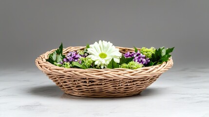 Woven basket with flowers on marble. Spring floral arrangement. Lifestyle photography