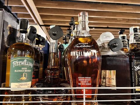 Kyiv, Ukraine - February 11, 2025: Close-up of premium whiskey bottles displayed on store shelves with labels visible