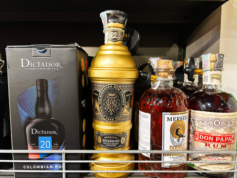 Kyiv, Ukraine - February 11, 2025: Selection of premium  rum bottles displayed on a shelf in a liquor store