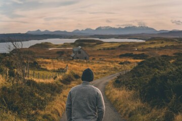 Fototapeta premium man walking in the mountains mountain landscape with lake and mountains Scotland Fall Autumn