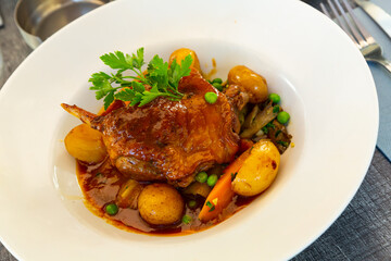 French cuisine, braised duck leg served with stewed vegetables