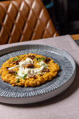 Risotto with pumpkin and walnuts served in a restaurant