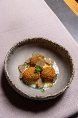 Crispy burrata with tartufo sauce served on a restaurant table