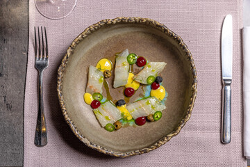 Raw white fish with jalapeño peppers served in a restaurant