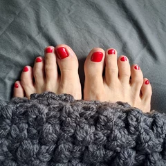  Image of two female finger's feet  with red nails © vali_111