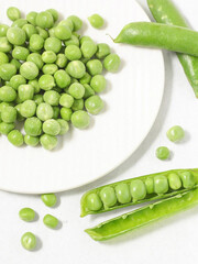 fresh green peas on a white plate 