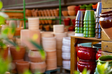 Rows with clay pots for plants in garden store