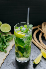 Refreshing mojito cocktail with lime, mint, and ice, served in a tall glass for summer drink