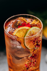 Refreshing floral cocktail with dried lime and petal garnish in an elegant glass, perfect for events