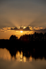 river at sunset, the colorful sky and clouds are reflected on the river