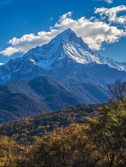 Majestic Snow-Capped Mountain Surrounded by Fall Foliage and Blue Sky : Generative AI