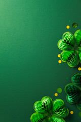 Honeycomb paper shamrocks and golden confetti on vibrant green background. Happy St. Patrick's Day...
