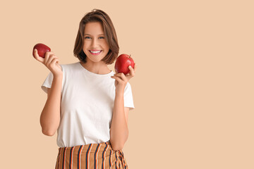 Beautiful young happy woman with fresh apples on beige background. Diet concept
